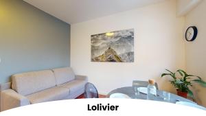 a living room with a couch and a table at Les appartements du Général Uhrich - Proche Parlement in Strasbourg