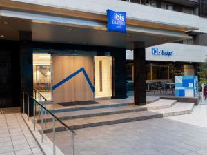 a store with a blue sign on the front of a building at ibis Budget Osaka Umeda in Osaka