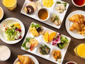 a table with plates of food on it at ibis Budget Osaka Umeda in Osaka