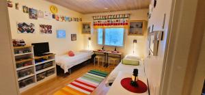 a small room with a bed and a table in it at House at the Arctic Circle- next to Santa Claus in Rovaniemi