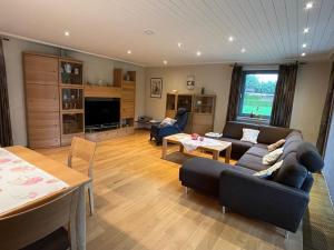 a living room with a couch and a table at Ferienhaus Ida in Simmerath