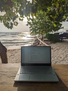 a laptop computer sitting on a table on the beach at Cabaña Villa Eugenia in Rincón