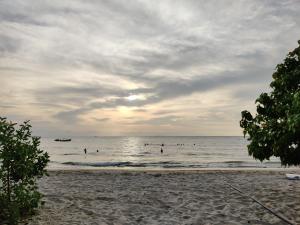 a group of people in the water at the beach at Cabaña Villa Eugenia in Rincón