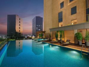 a large swimming pool in front of a building at Grand Mercure Ahmedabad GIFT City - An Accor Hotels Brand in Gandhinagar