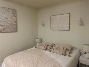 a bed in a room with two pictures on the wall at Logis de Russay in Saivres