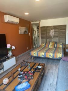 a living room with a bed and a coffee table at Bellevue in Montpezat-de-Quercy