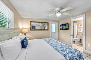 a bedroom with a bed and a ceiling fan at The Solaster in Siesta Key +62 photos