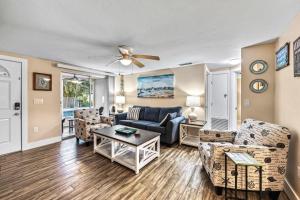 a living room with a couch and chairs at The Solaster in Siesta Key