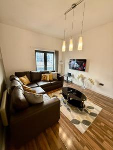 a living room with a couch and a table at Bloom Apartments - City Centre - Gated Parking in Manchester