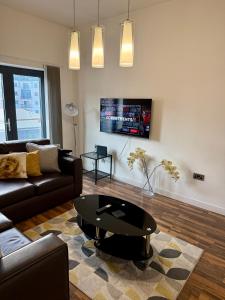 a living room with a couch and a coffee table at Bloom Apartments - City Centre - Gated Parking in Manchester +47 photos