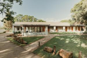 a house with rocks in front of it at Rosemary Hill Farm in Pretoria