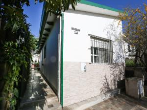 a white building with a door on the side of it at La Casa de los Pájaros in Tanti