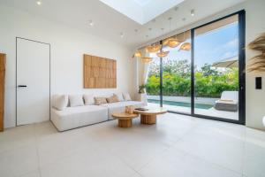 a living room with a couch and a table at Ardhana 5 - Private Pool Retreat - Brand New Villa in Ungasan