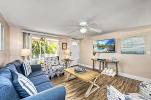 a living room with a blue couch and a table at Casita Morning Star - 6920 in Siesta Key