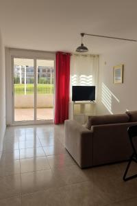 a living room with a couch and a flat screen tv at primavera ocean apartament residence pool in Arona +3 photos