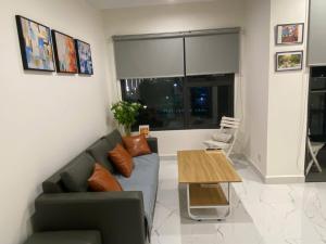 a living room with a couch and a table at Parkview Homestay BS802 The Beverly Solari Vinhomes Grand Park in Tân Vạn