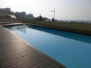 a large swimming pool on a building with blue water at 25m2 Grande Plage, hypercentre, balcon in Biarritz