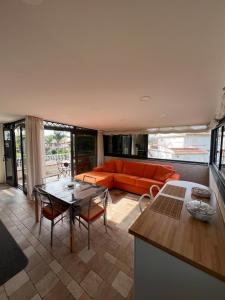 a living room with an orange couch and a table at A Casa Di Mimmo in Fondachello