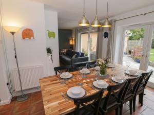 a dining room with a wooden table and chairs at Harran in Peopleton