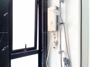 a shower in a bathroom next to a window at Beacon Executive Suite with SkyPool 3BR 8pax Georgetown Penang in Georgetown +35 photos