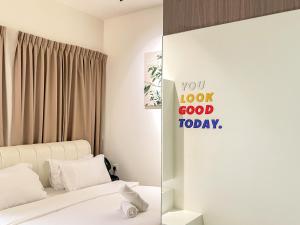 a bedroom with a bed and a mirror with the words you look good today at Beacon Executive Suite with SkyPool 3BR 8pax Georgetown Penang in Georgetown