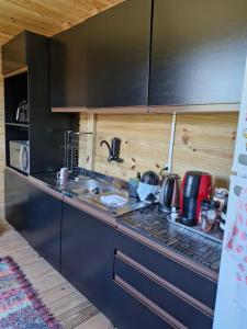 a kitchen with a sink and a counter top at Casa 1 quarto 2 pessoas a 3 km da Oktoberfest in Blumenau +13 photos