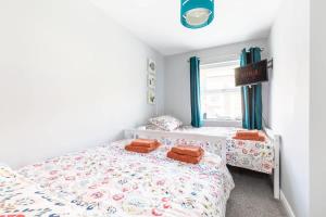 a bedroom with two beds and a window at Townhouse Harbour Retreat in Scarborough
