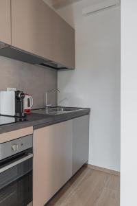 a kitchen with a sink and a counter top at LaNica Maison in Castelfranco Emilia +5 photos
