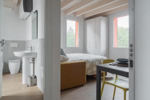 a bedroom with a bed and a table in a room at LaNica Maison in Castelfranco Emilia