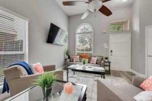 a living room with couches and a ceiling fan at Updated, Comfortable, And Quiet Space! in Trinity Mills