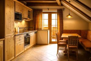 a kitchen with a table and a dining room at Alpska Perla Apartments in Cerkno +74 photos