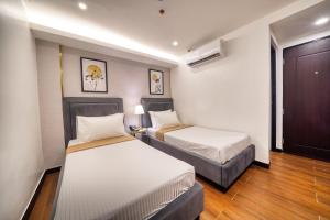 Ένα ή περισσότερα κρεβάτια σε δωμάτιο στο Everyone Hotel