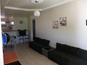 a living room with a couch and a table at Cobertura Porto de Galinhas in Porto De Galinhas