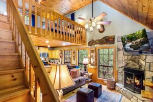 een woonkamer met een trap en een open haard bij Gunny's Cabin in Stewart Mill