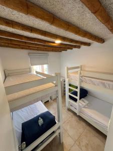 a room with three bunk beds in a house at Condominio Maradentro - Casas de playa en exclusivo balneareo de chepeconde in Los Leones