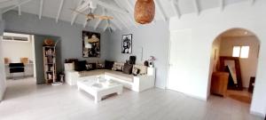a living room with a couch and a table at Villa Amour - Orient Bay beach in Orient Bay