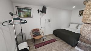 a bedroom with a bed and a chair in it at Casa do Apeadeiro in Vila Pouca de Aguiar