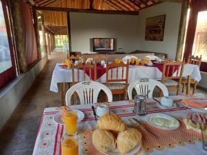a table with bread and orange juice on it at Pousada Campina do Monte Alegre in Campina do Monte Alegre
