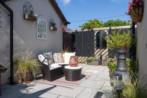 a patio with a couch and a table at TyCosy in St. Davids