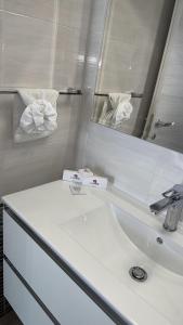 a bathroom with a white sink and a mirror at Le bougainvillea 2 in Corbetta +28 photos