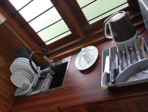 a kitchen with a sink and a mirror at Amara Garden Villa in Kadawata
