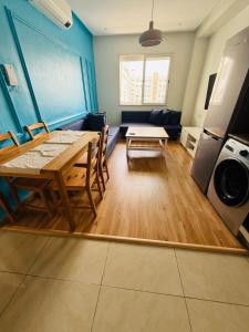 a living room with a wooden table and a couch at Chic appartement agadir with pool&balcony in Agadir