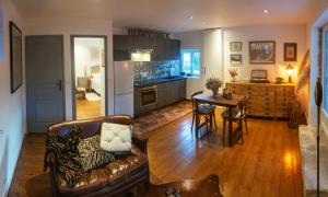 a kitchen and living room with a couch and a table at La Grange in Savenay