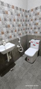 a bathroom with a toilet and a sink at MMS Residence in Ranipet +26 photos