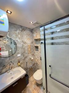 a bathroom with a toilet and a sink and a shower at Sheraton ganna view inn in Alexandria