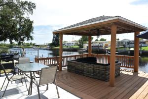 a wooden deck with a gazebo and a table and chairs at Enjoy Sunset with Dolphin and Manatee in Hudson