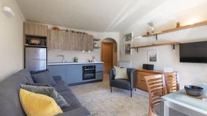 a living room with a couch and a kitchen at Villa Nice View in Ponte di Legno