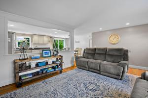 a living room with a couch and a table at 111 Eileen Street Yarmouth Port - Starfish Escape in Yarmouth