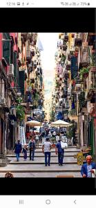 a group of people walking down a city street at Casa Fabrizio Ai Gradoni Di Chiaia in Naples
