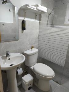 a bathroom with a white toilet and a sink at Estela in Santo Domingo